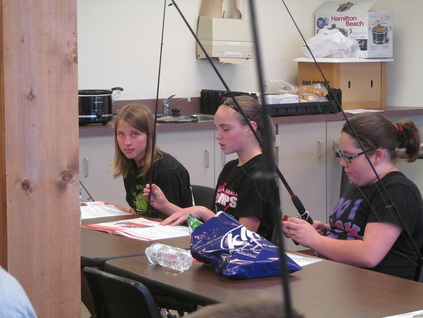 Student setting up rod and reel